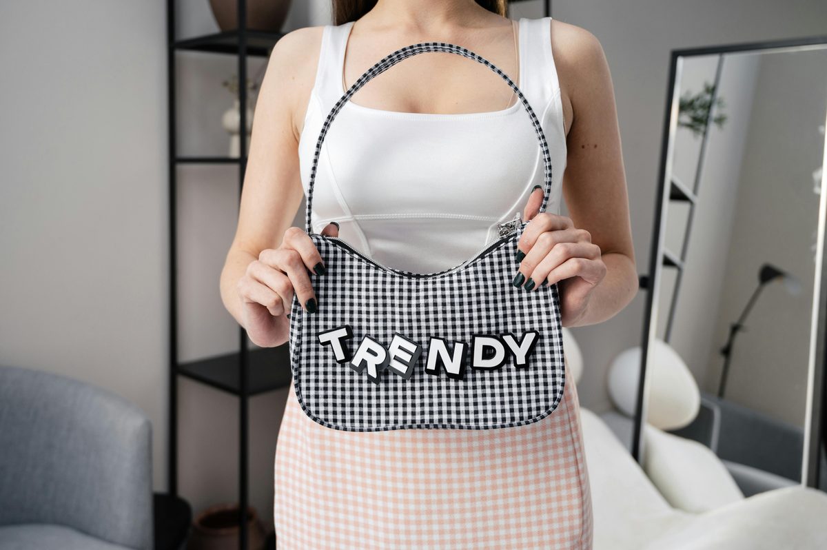 Creator holding a trending handbag toward the camera — every link comment in her TikTok comments is a missed sale