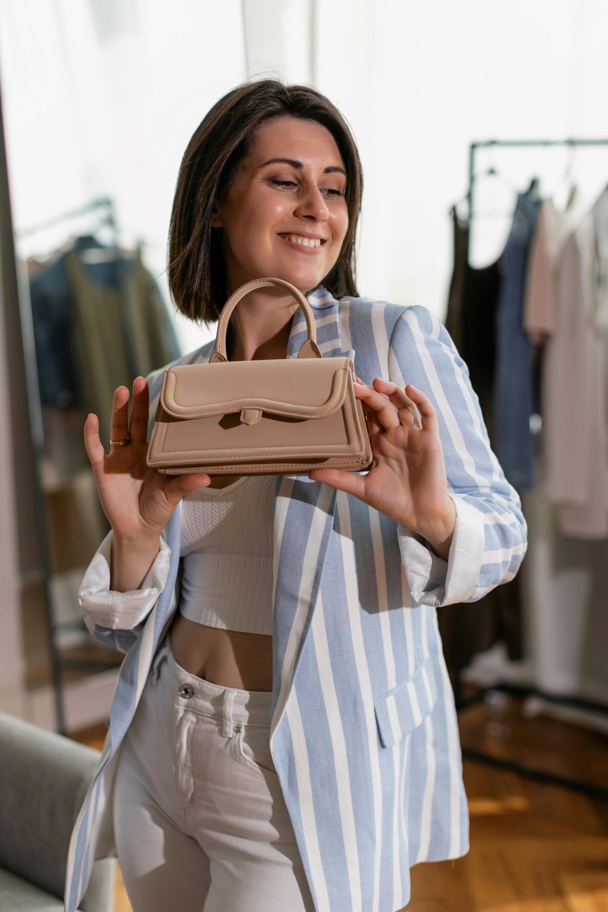 Creator presenting her own private label branded handbag launched through Drop That Bag OEM from 50 units minimum