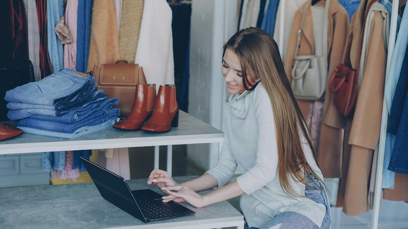 Independent boutique buyer sourcing trending handbags on her phone in 2026