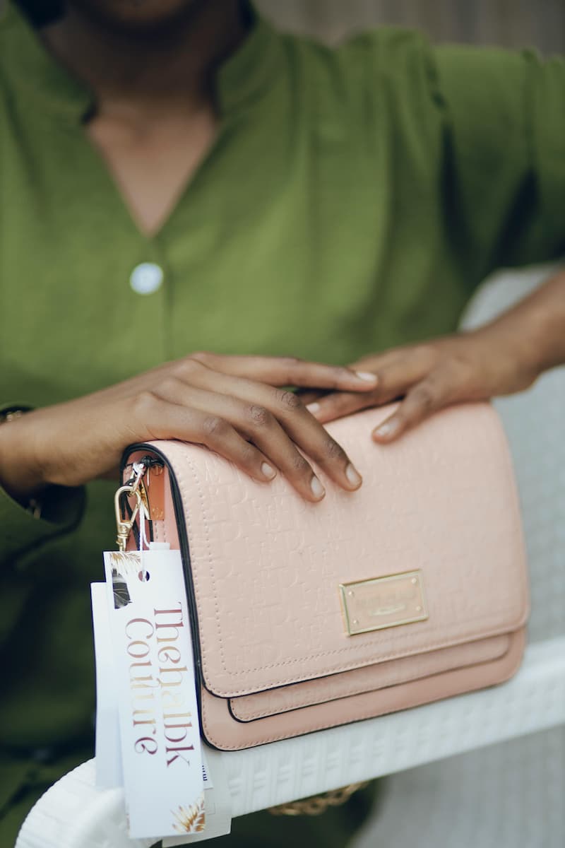 Boutique owner reviewing a private label handbag prototype for her own-label collection launch