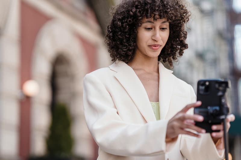 Creator holding a trending bag and phone ready to submit sourcing request