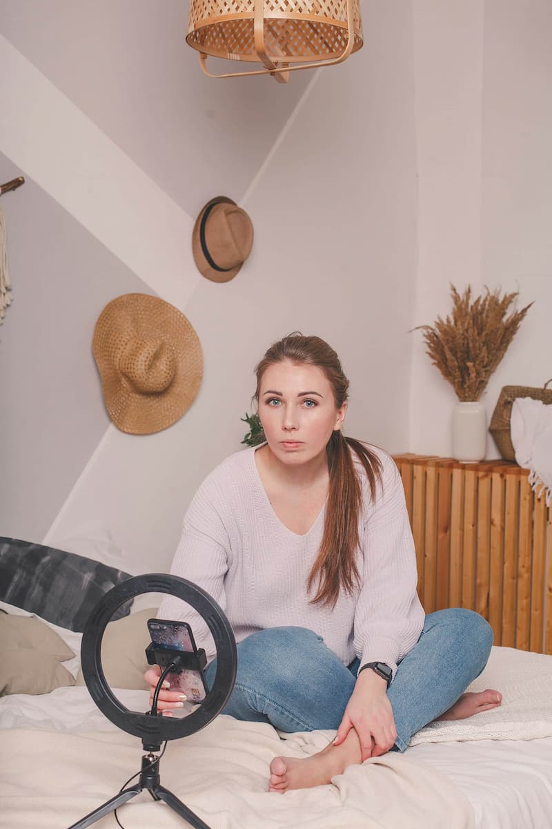 Creator setting up her ring light and phone to film a teaser story for her bag drop
