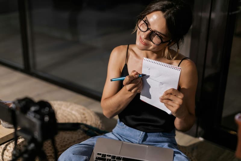 Creator at her laptop planning her next bag drop strategy and timeline