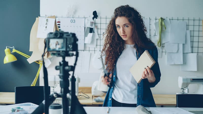 TikTok creator scrolling her feed spotting a trending handbag signal early