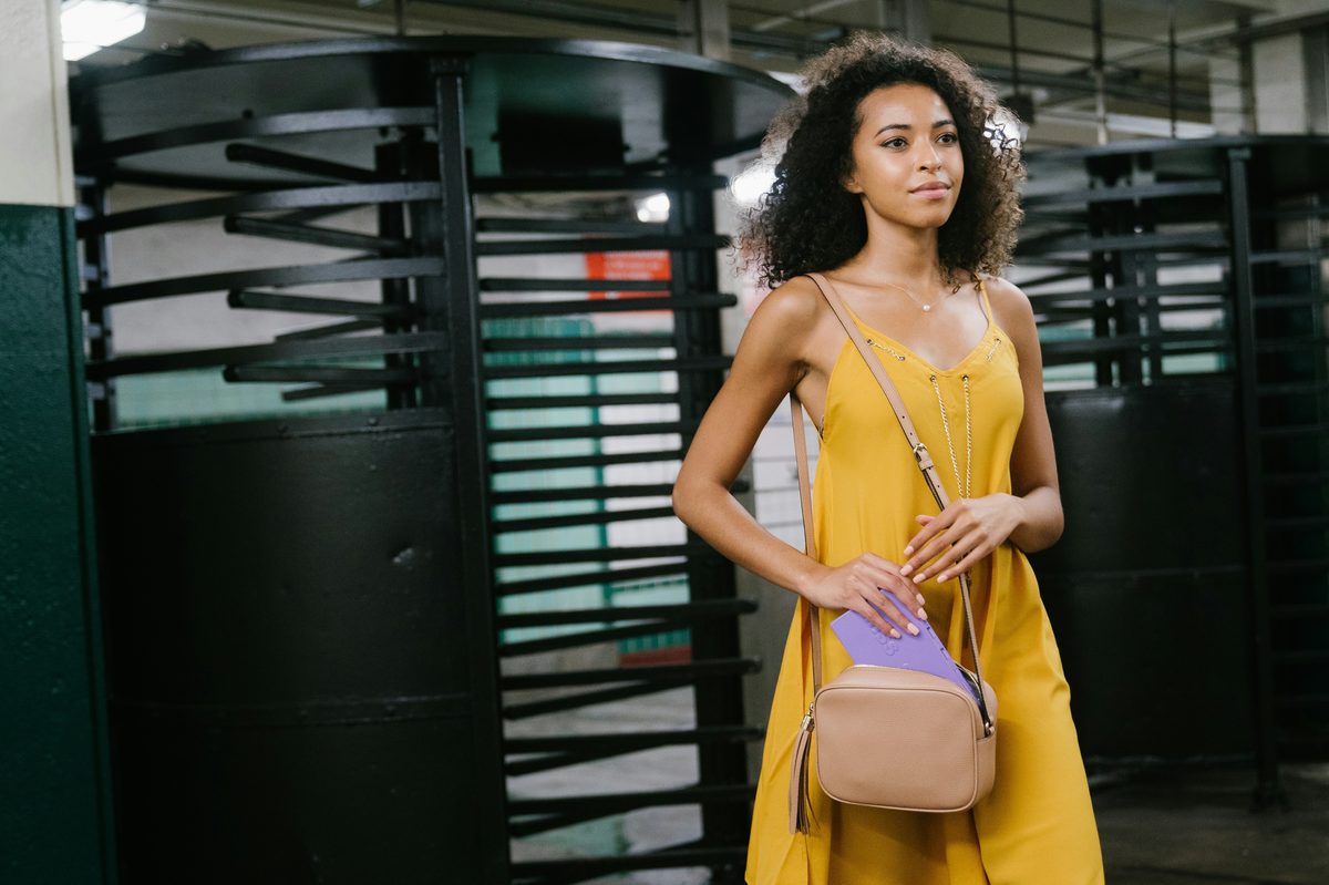 Young woman wearing a crossbody bag — the type of audience member who buys from a TikTok creator she follows