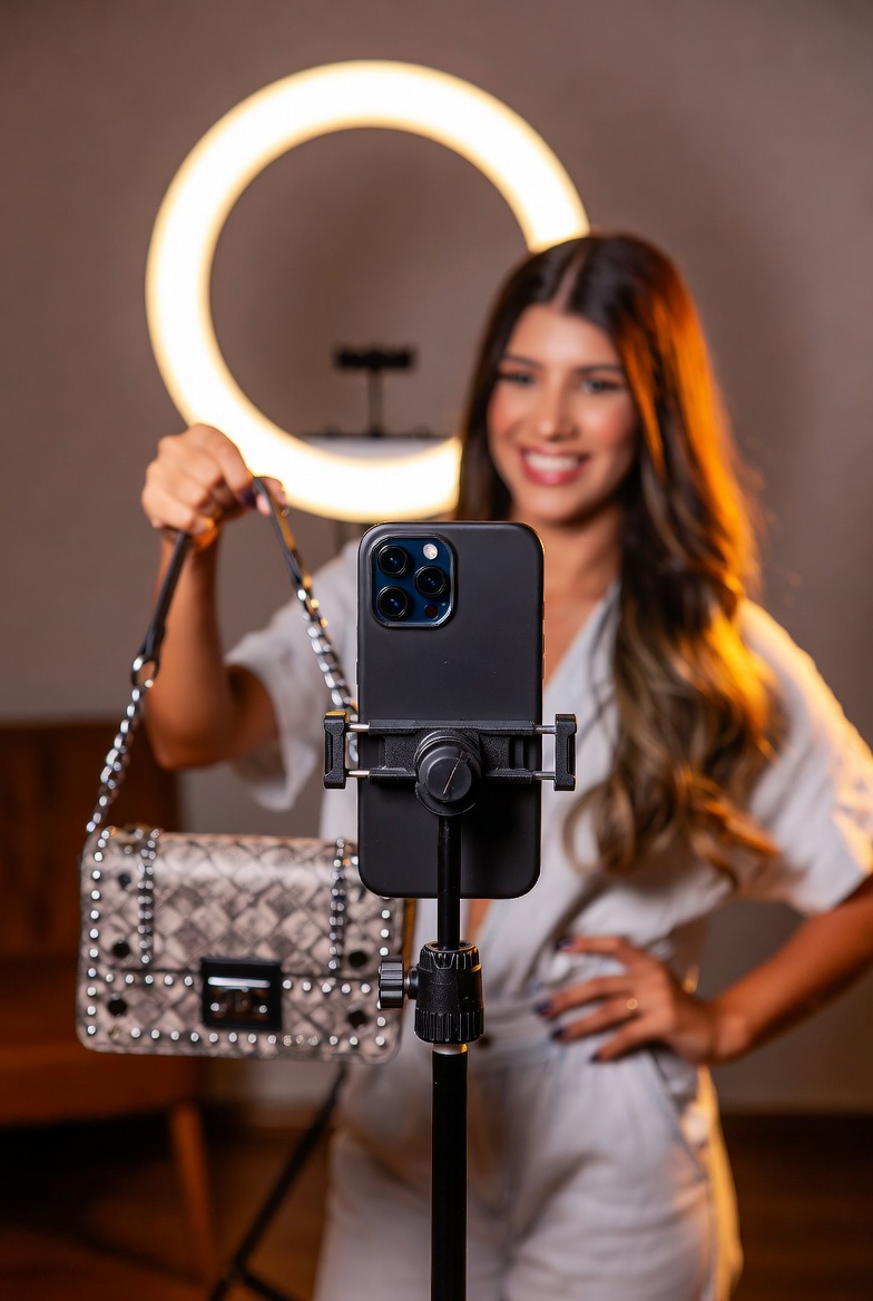 Instagram creator filming a handbag drop on TikTok with ring light to resell to followers